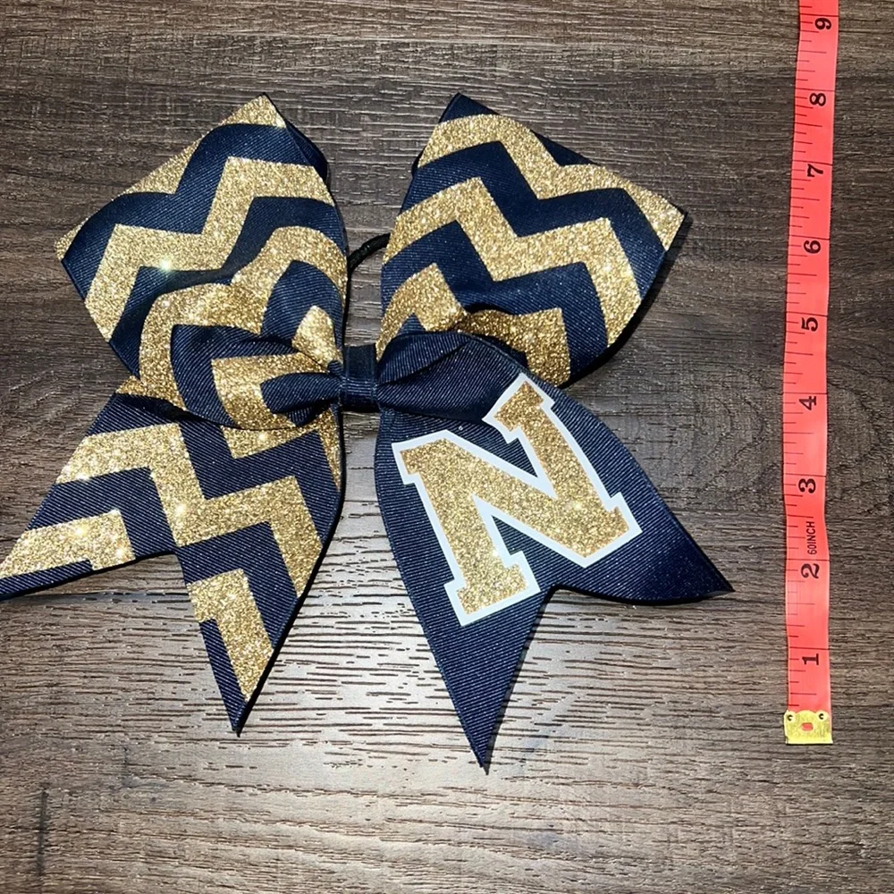 Brand new! Navy & Gold “N” Cheerleading Bow